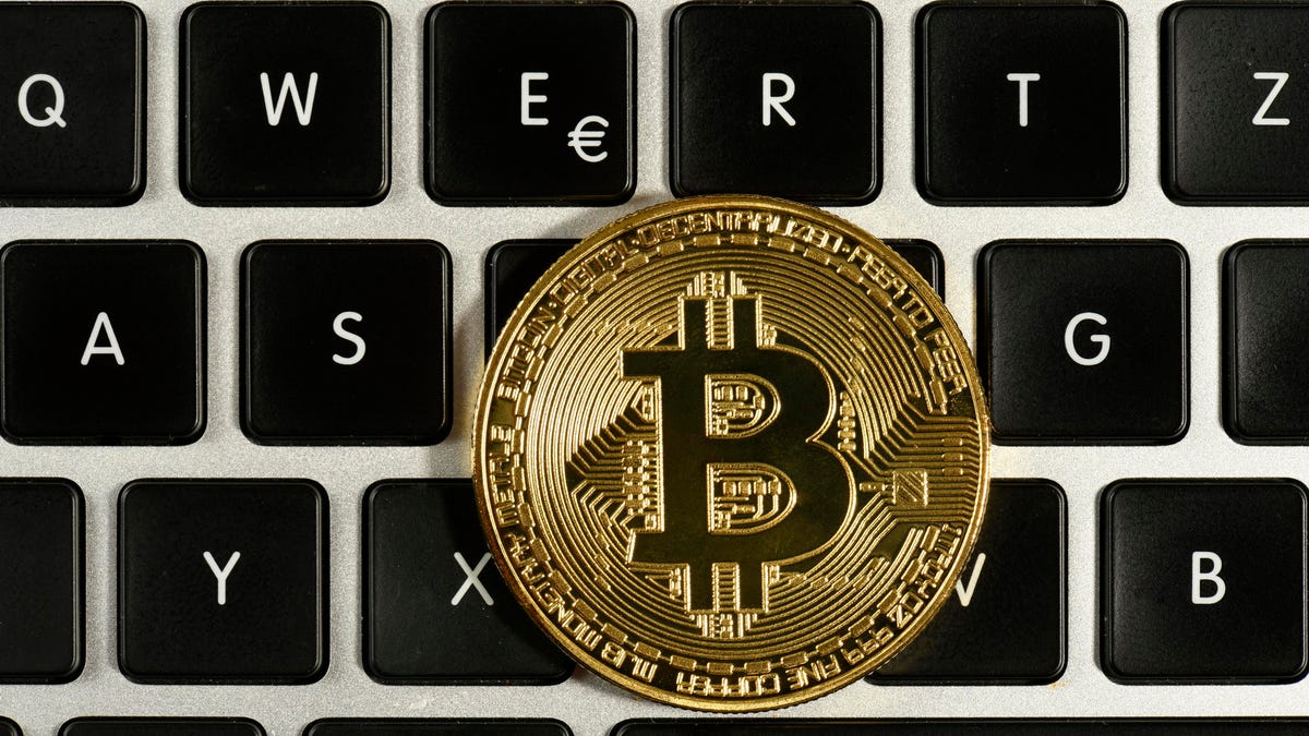 Symbol image digital currency, gold physical coin bitcoin on keyboard