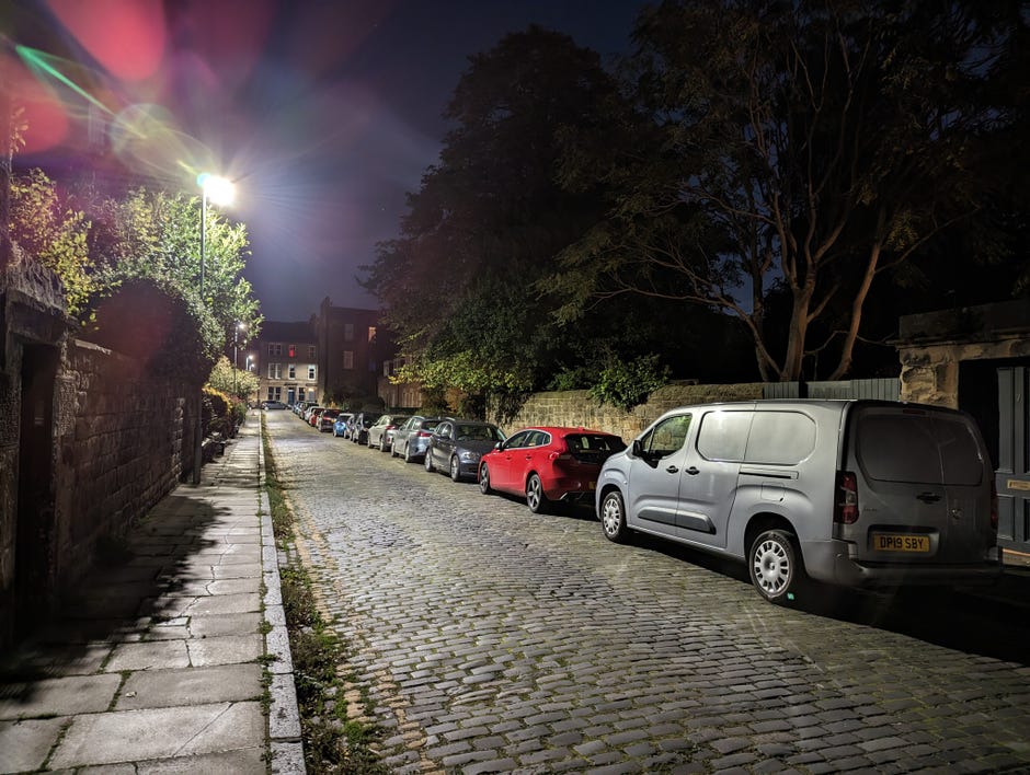 Une image montrant une rue de nuit avec des éclats de lentille provenant d'un lampadaire
