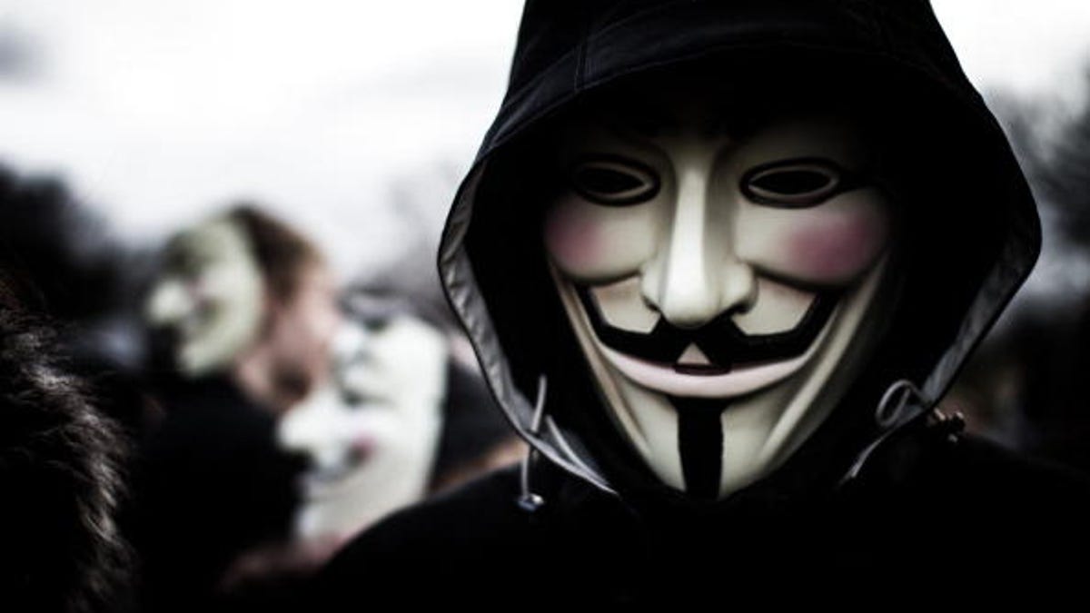 Person wears a Guy Fawkes mask which today is a trademark and symbol for the online hacktivist group Anonymous. 2012.