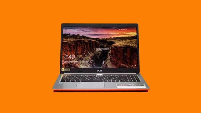 An Acer Aspire 5 laptop on an orange background.