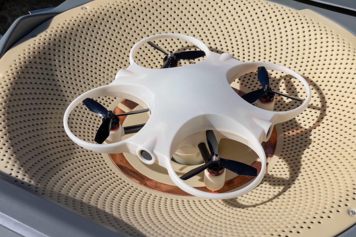 Sunflower Labs' drone rests in a dished compartment with copper charging contacts.