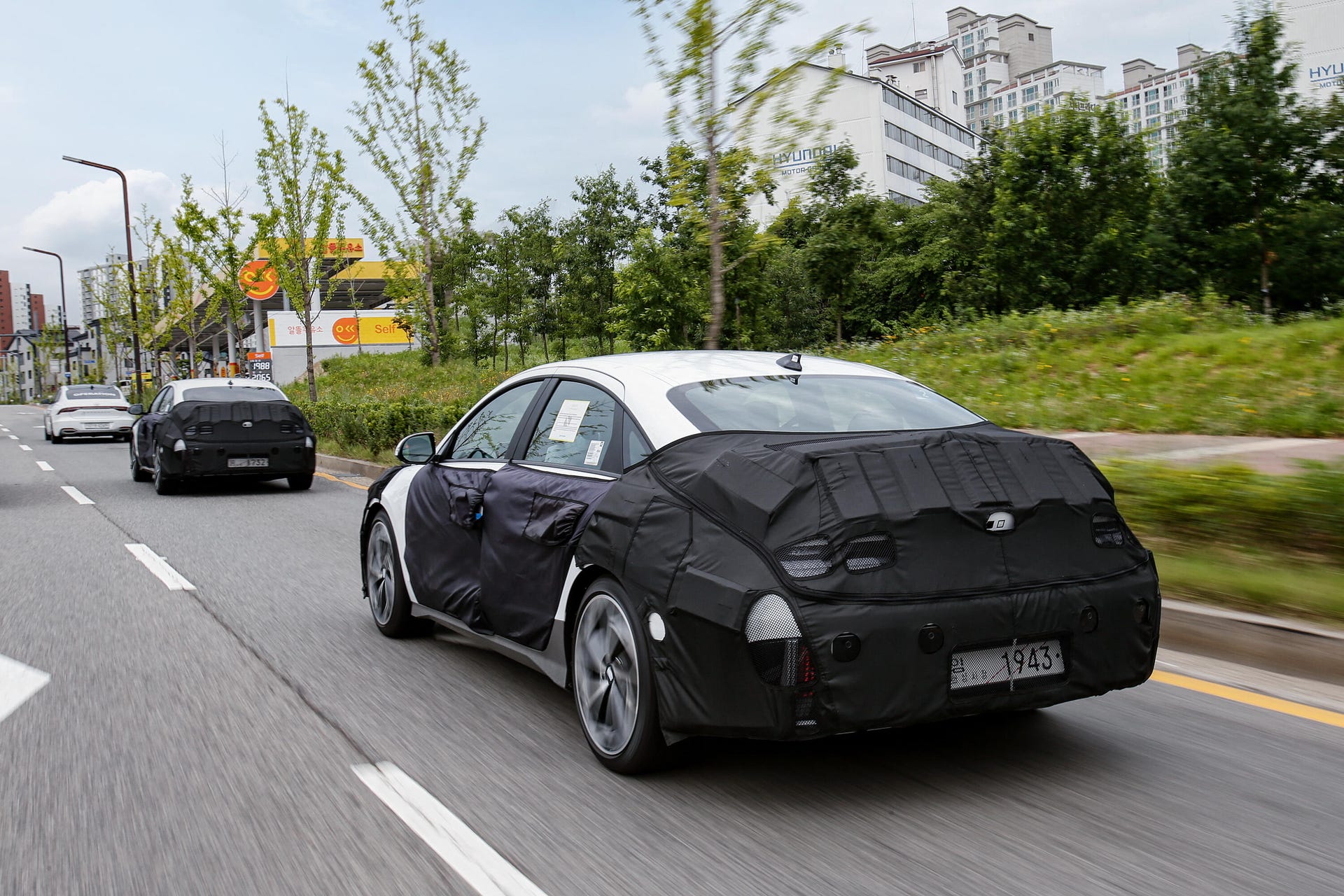 Rear 3/4 view of a camouflaged 2024 Hyundai Ioniq 6 prototype