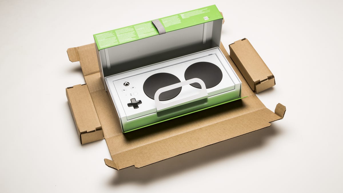 Microsoft's Xbox Adaptive Controller sits in the cardboard box used for shipping.