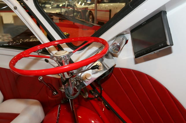 A Kenwood touch screen is mounted to the front of the Isetta.