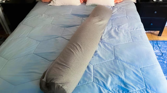 Frida Mom Adjustable Keep-Cool Pregnancy Pillow on bed