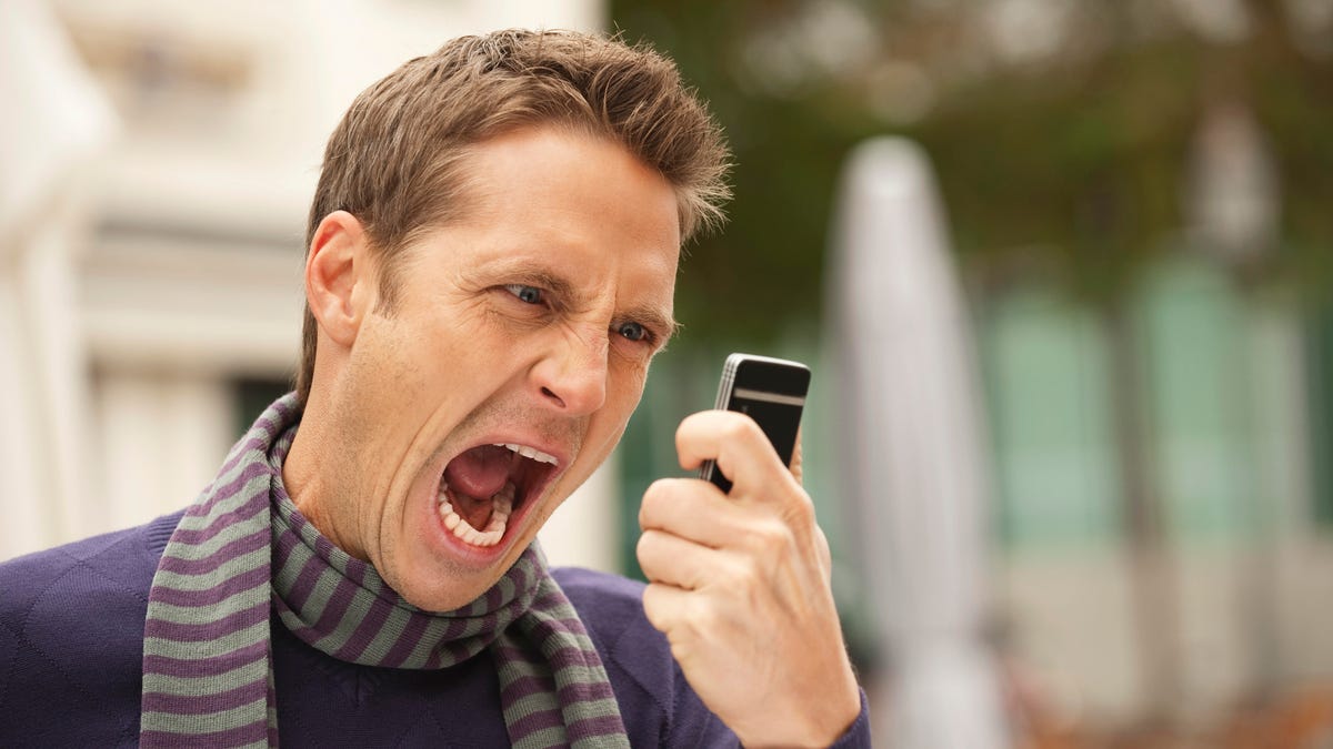 Man screaming into mobile phone