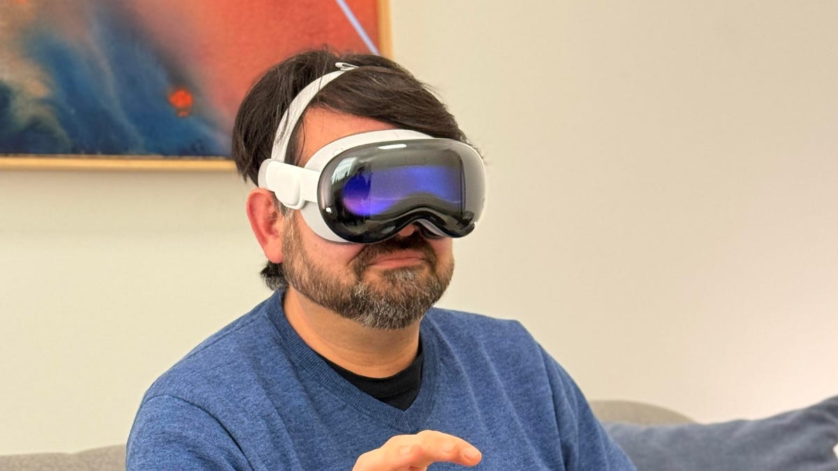 A man wearing a Vision Pro headset from Apple