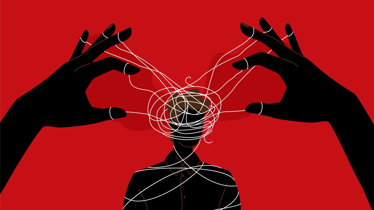 An image of hands connected to strings wrapped around a man's head