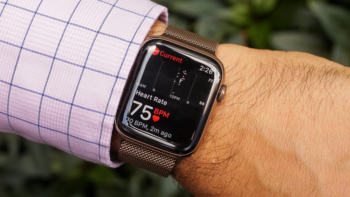 A wrist with a smartwatch showing heart rate
