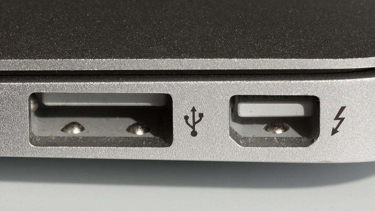 It can take a little concentration to figure out which way is up when using a USB port such as this one on a MacBook Air; the Thunderbolt port to the right is keyed to make orientation a bit easier. A new USB connector on the way will be reversible so it won&apos;t matter which way people plug it in.