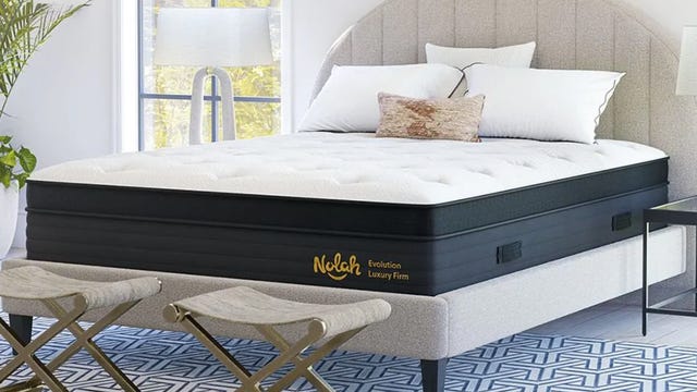 The Nolah Evolution 15 mattress on top of a beige bed frame.