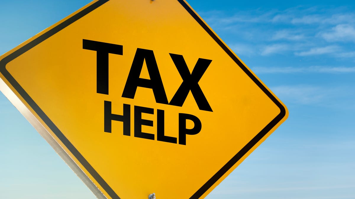 a yellow road sign reading Tax Help in big black letters