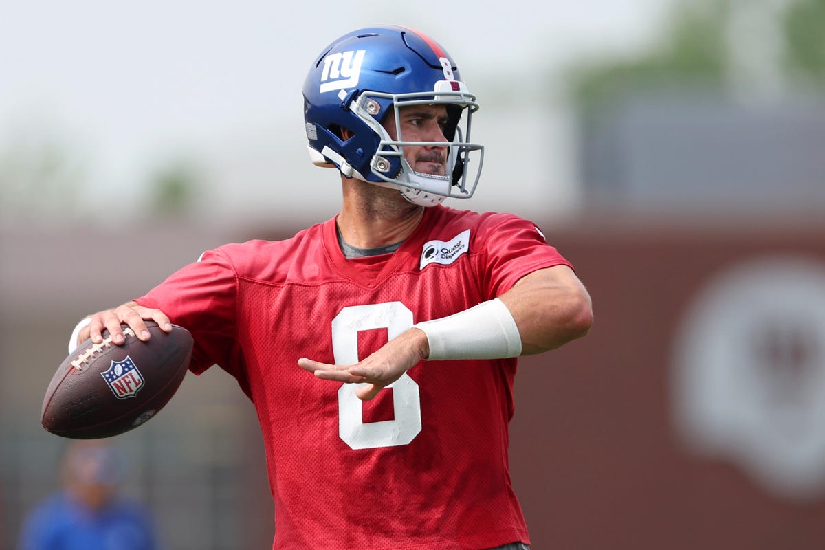Daniel Jones of the New York Giants holds a football in his hand at training camp.