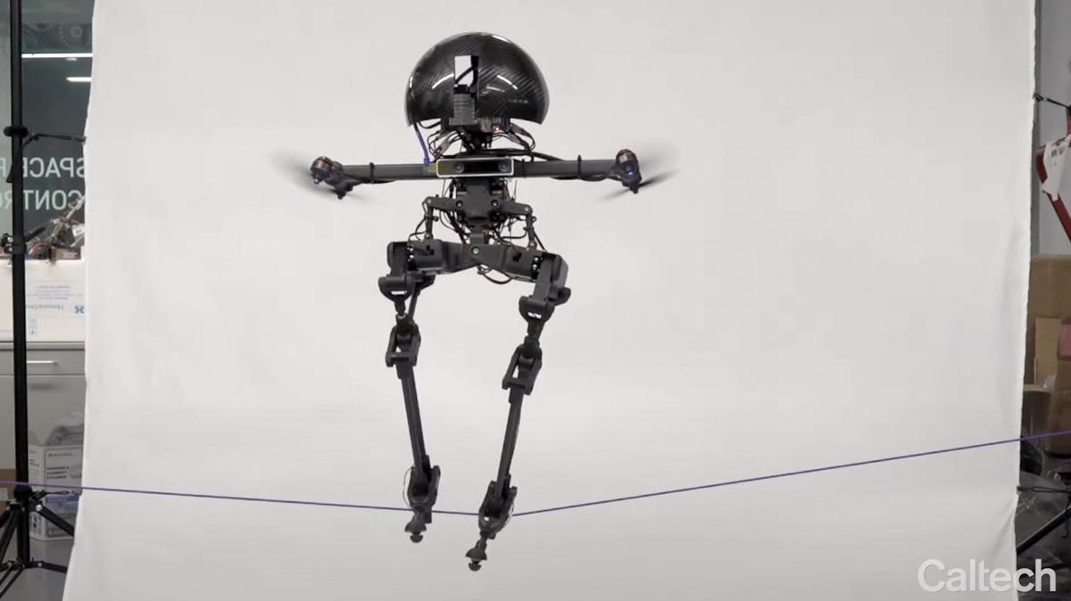 A robot with legs and dronelike propellers balances on a slackline