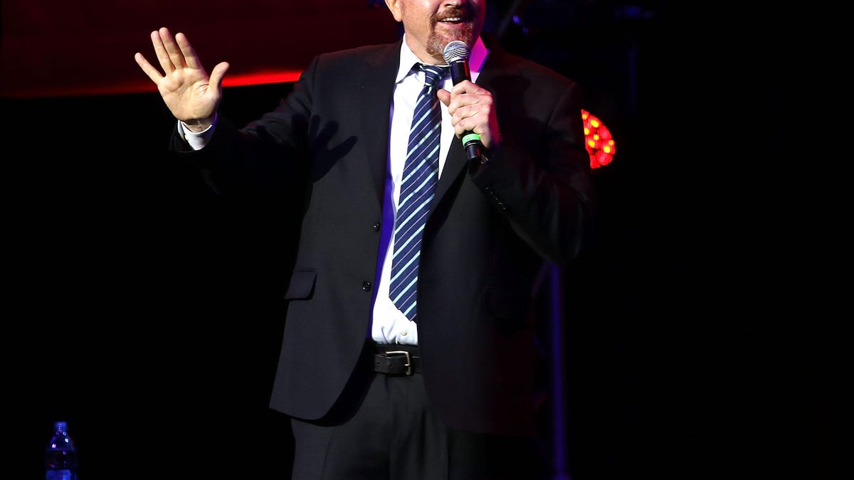Louis C.K. performs stand-up on stage