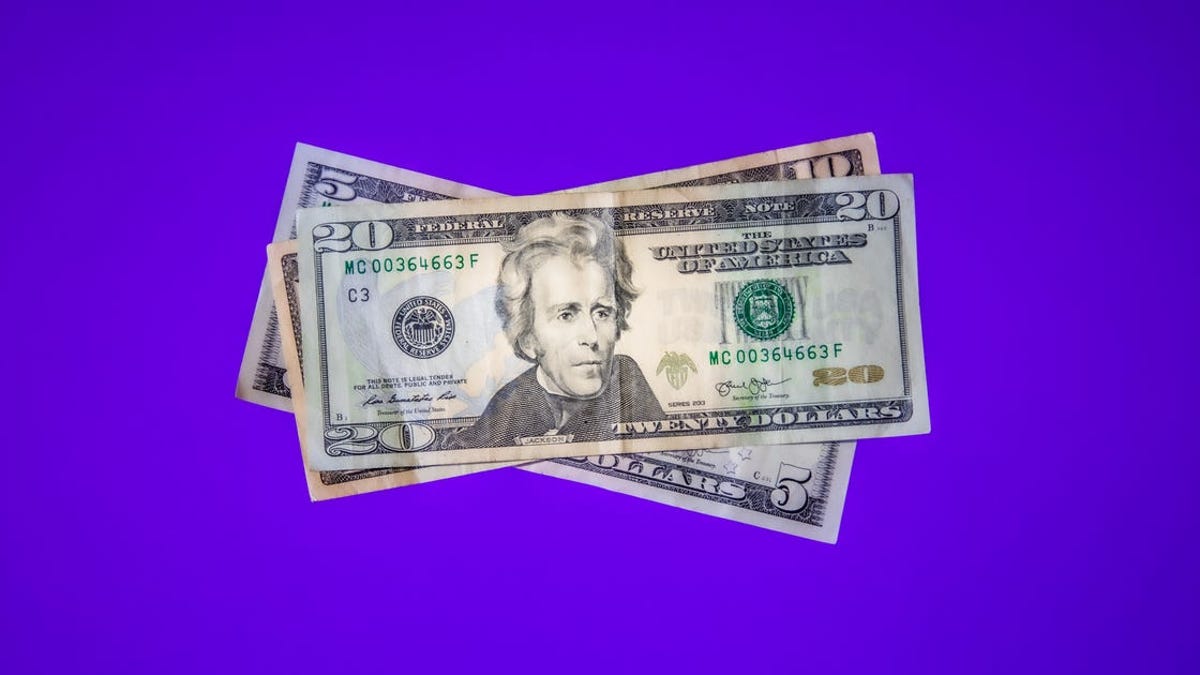 $20 bills on a purple background