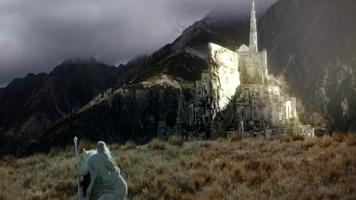An alabaster cliffside castle, with a white wizard on horseback in the foreground