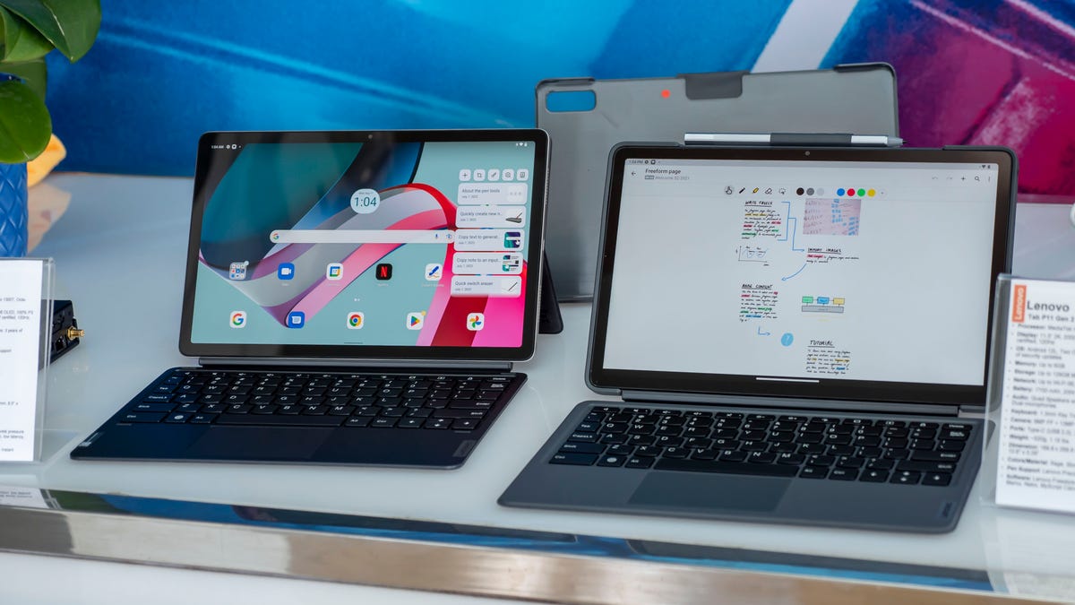 Side by side Lenovo P11 and P11 Pro second-generation tablets on a table with Bluetooth keyboards connected.