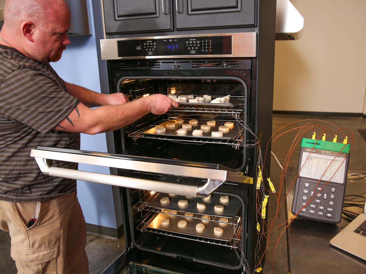 Person placing food onto an oven rack