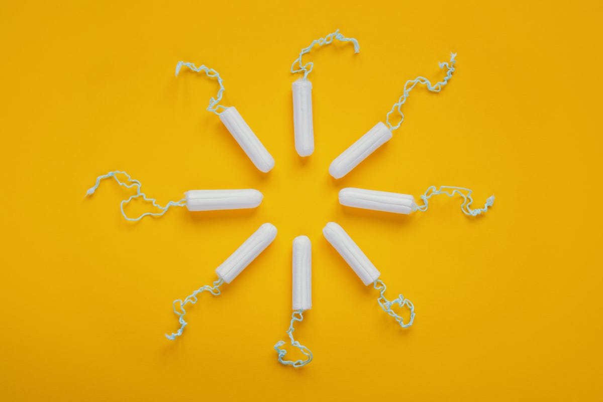 Tampons arranged to make a sun shape against a bright yellow background