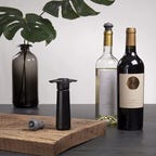 vacu vin wine preserve and bottles of wine on table