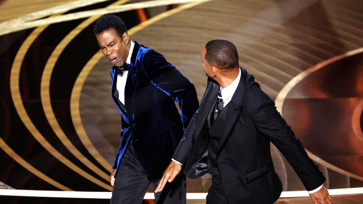 Chris Rock recoils after being slapped by Will Smith at the 2022 Oscars.