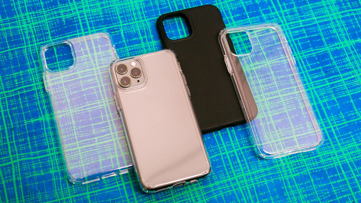 Clear and black Spigen phone cases and an iPhone against a green and blue background.