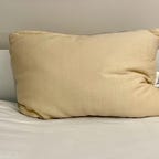 Birch Organic Pillow on a white bed