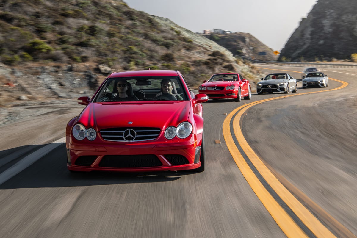 Head-on view of a Mercedes-Benz CLK63 AMG Black Series traveling on a highway, with other Mercedes following