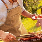 man grilling in apron