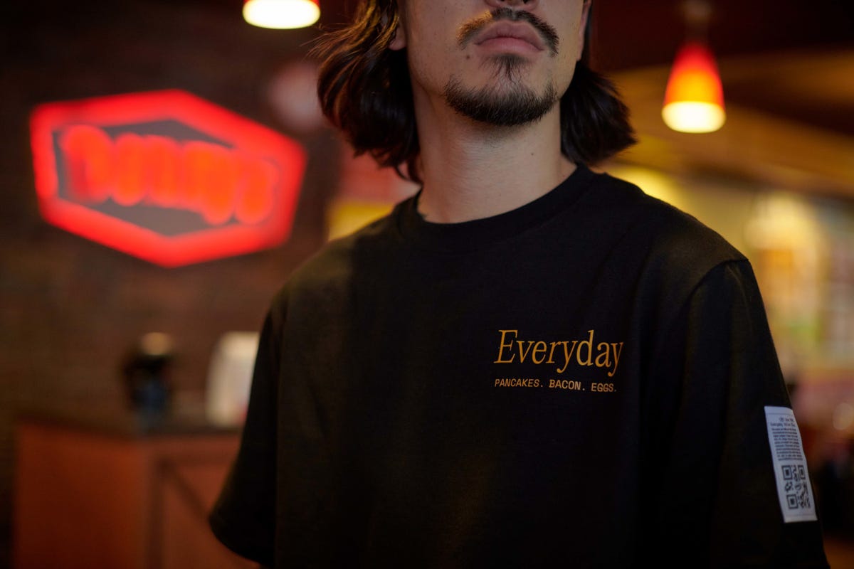 Man wearing Denny's Everyday Value t-shirt