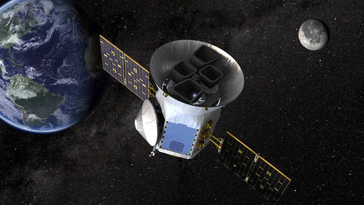 NASA's silver TESS spacecraft in illustration with Earth and Moon in the background.