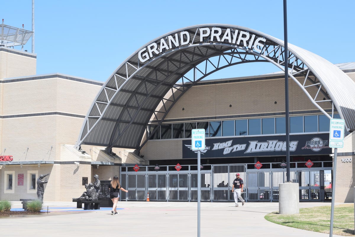 stadium entrance with an arch that says 