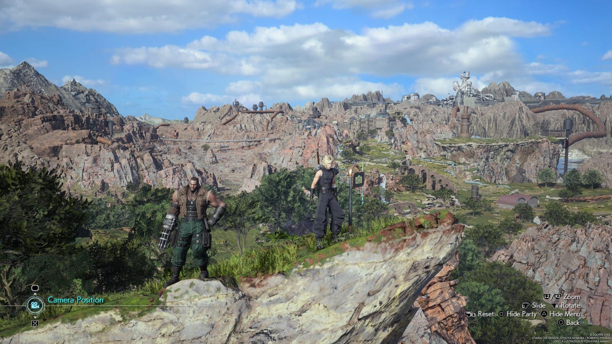 Characters stand on a rock spur overlooking grasslands.