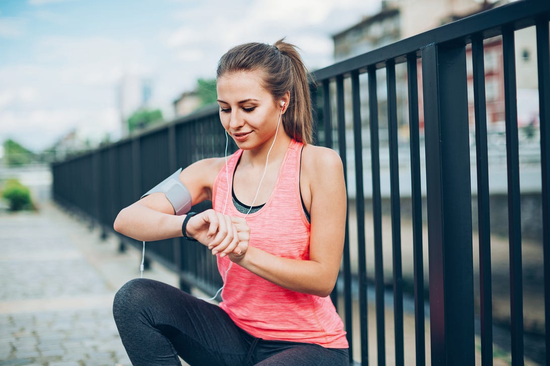 Woman in exercise gear checking her wrist