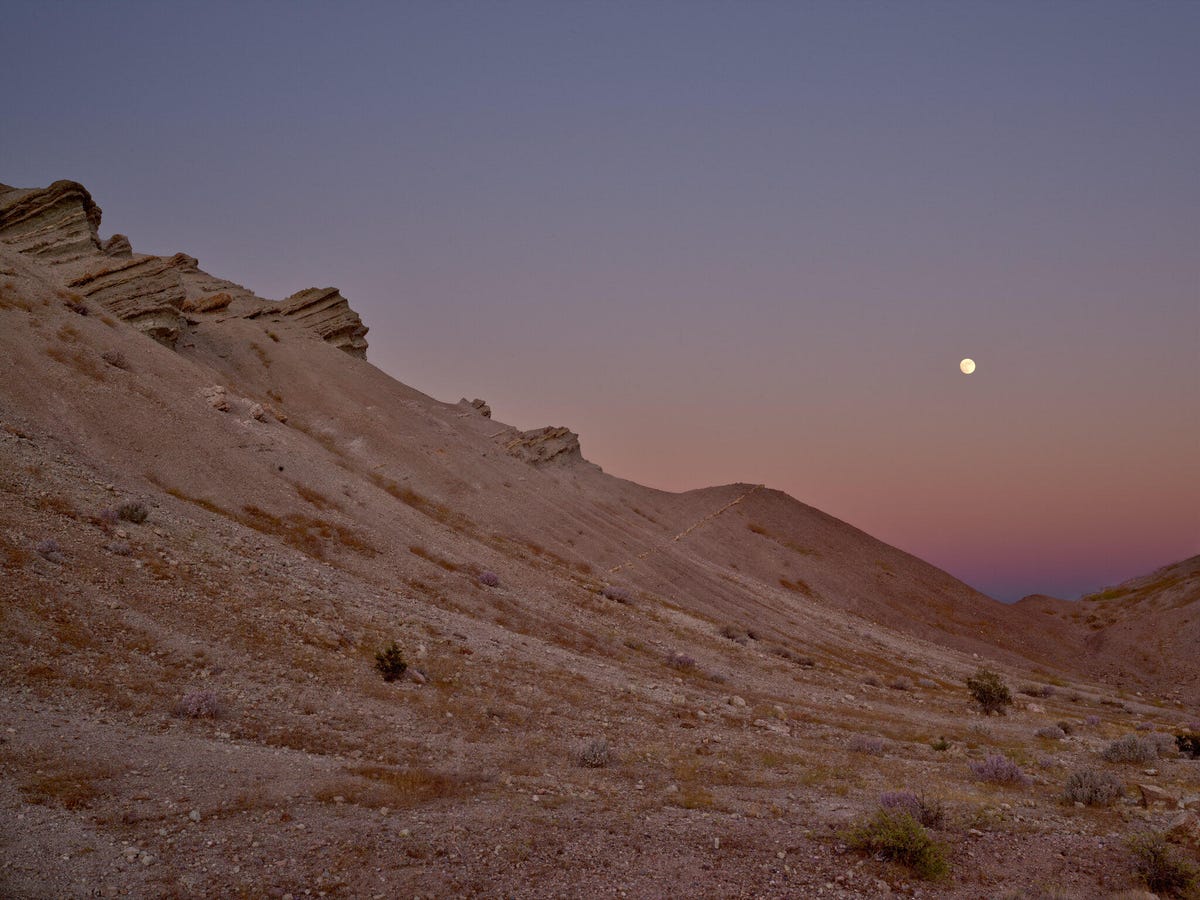 The subtle colors of the sky after sunset aren't as vivid as daytime hues, but I liked their contrast with the bright moon at Rainbow Basin State Park in California.