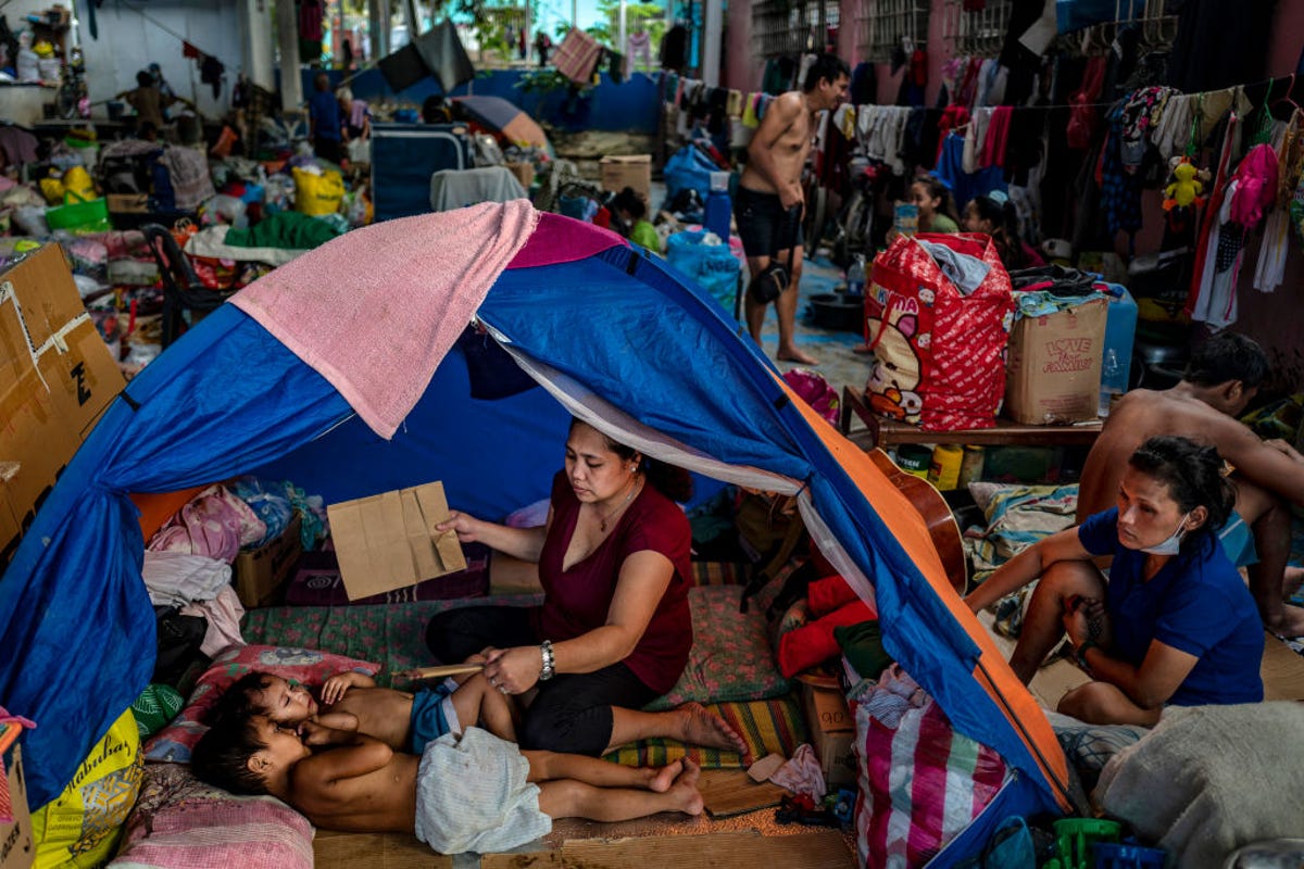 Residents of an evacuation center in the Philippines following a typhoon in 2020.