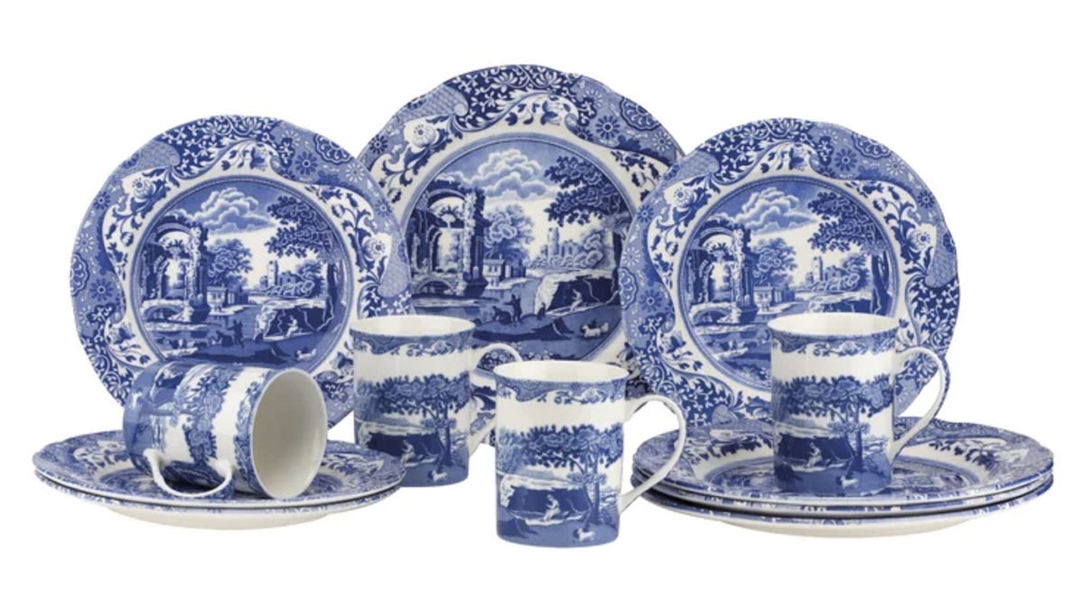 Spode fine china with pastoral scenes displayed on plates and cups in cobalt blue.