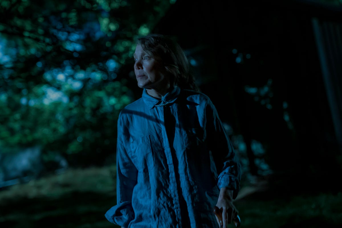 Sissy Spacek walking through the woods at night.