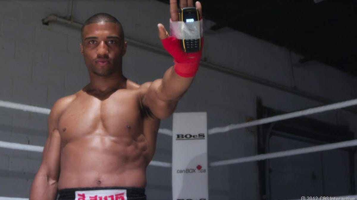 MMA fighter Simon Marcus throws punches with a Sonim Bolt rugged phone.
