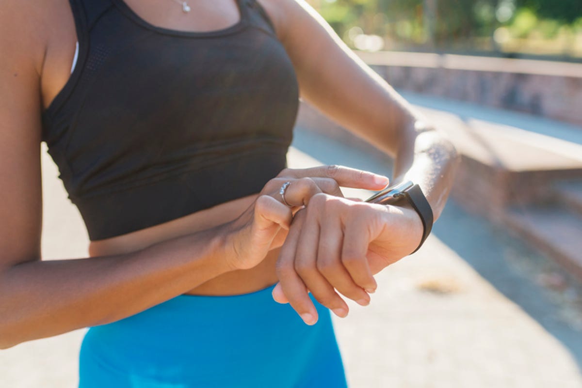 woman checking smart watch while exercising