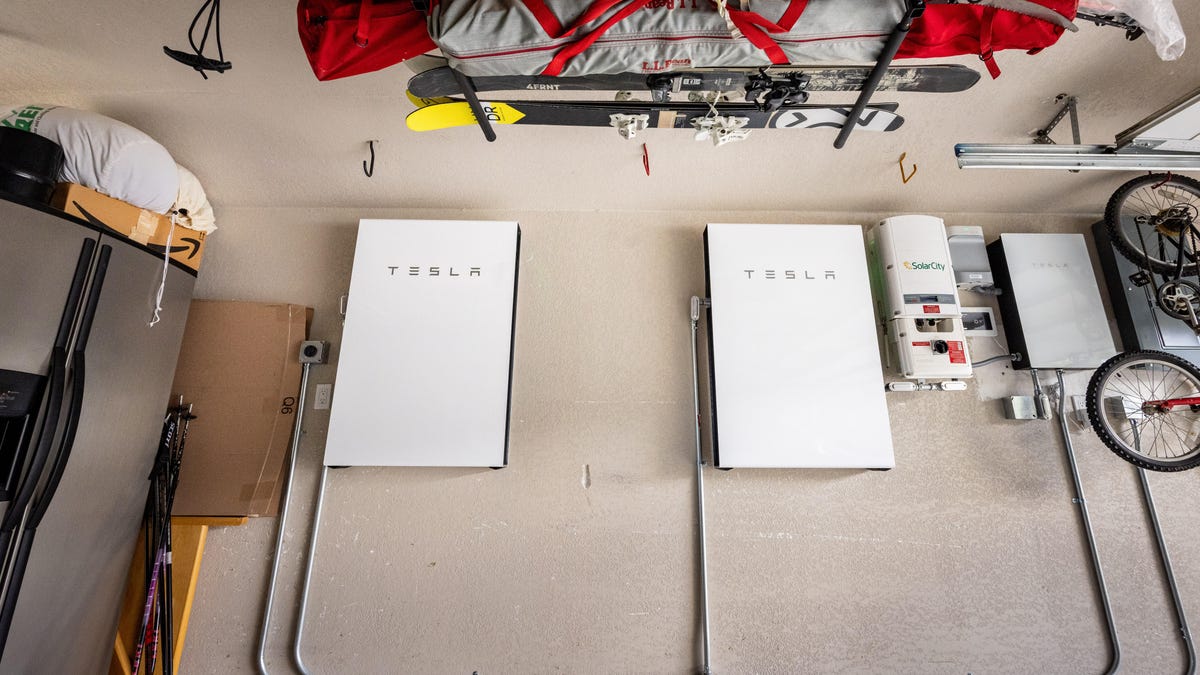 A pair of Tesla Powerwalls on a garage wall