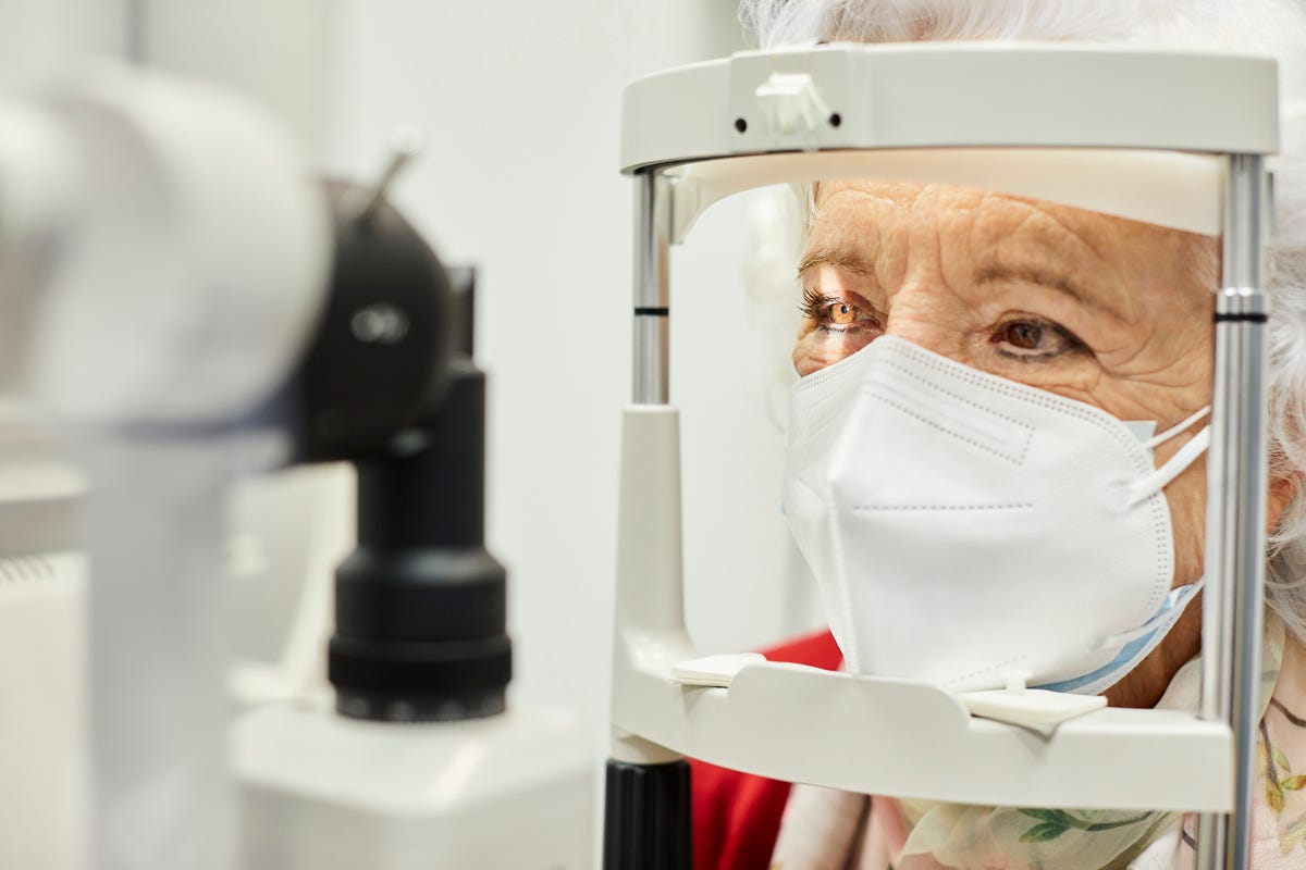 Aged woman getting an eye exam.