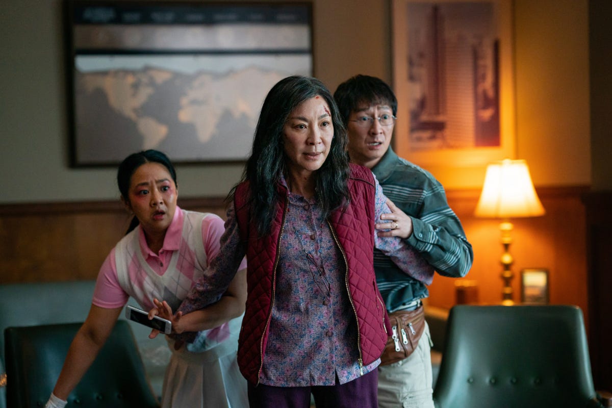 Stephanie Hsu, Michelle Yeoh and Ke Huy Quan standing in an office