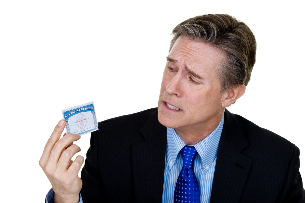Man looking at social security card