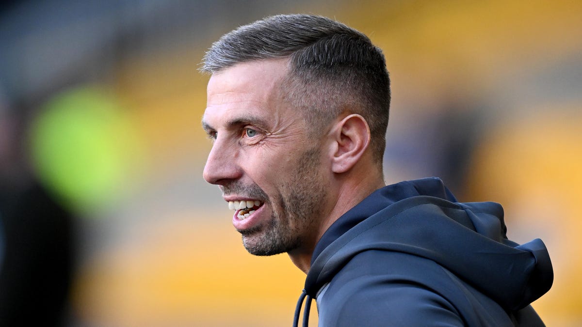 Side on image of Wolves manager Gary O'Neil, smiling.