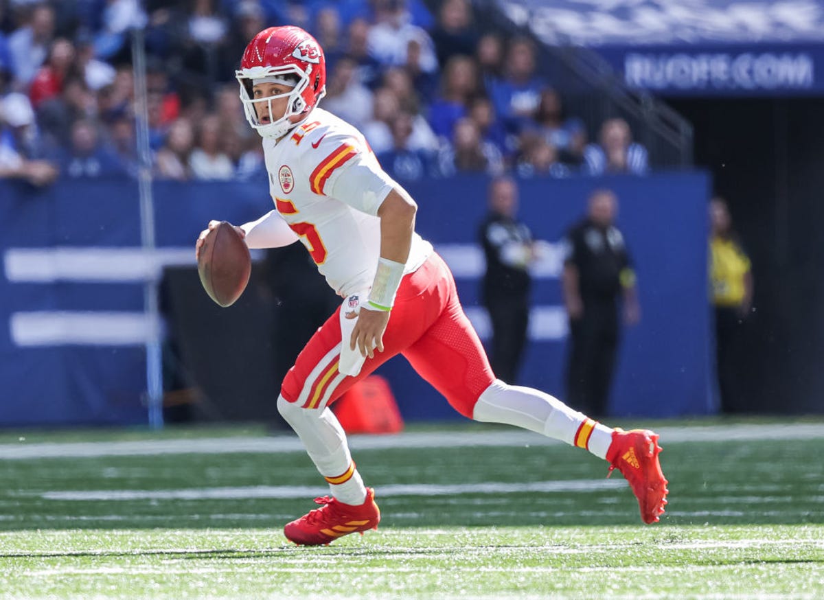 Patrick Mahomes of the Chiefs holds a football while running. 