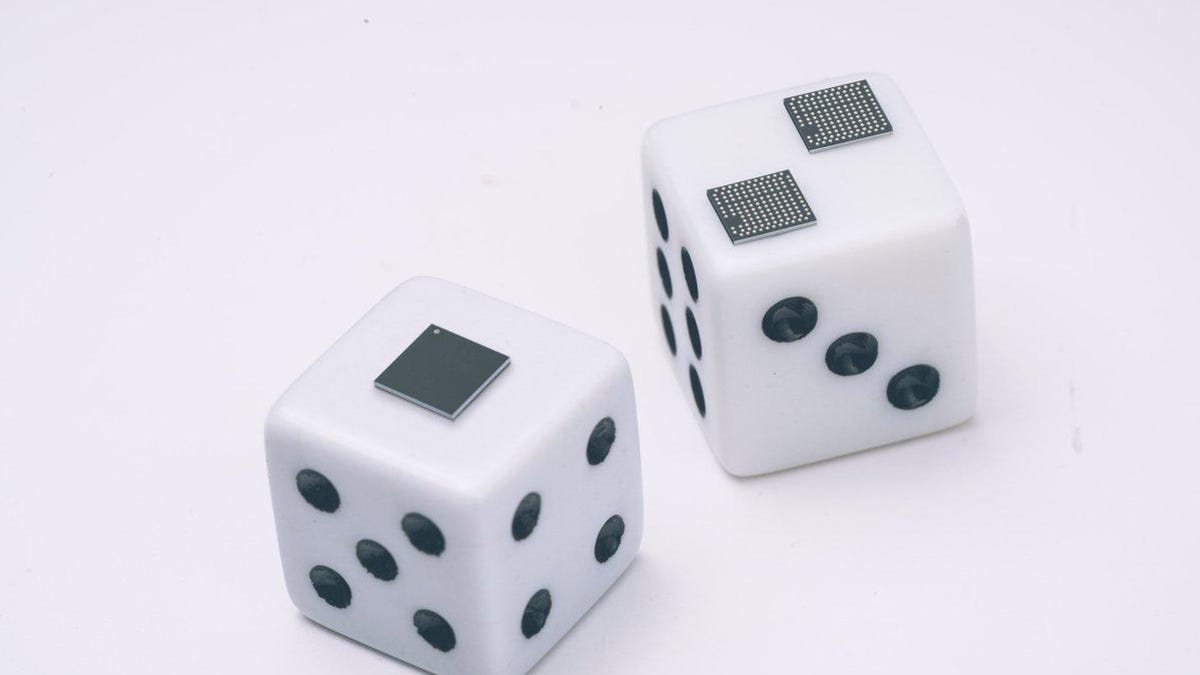 Google's tiny tensor processing unit (TPU) chips are shown perched on a pair of dice.