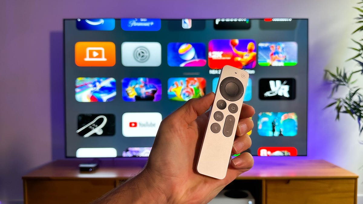 Siri Remote in front of the Apple TV 4K home screen