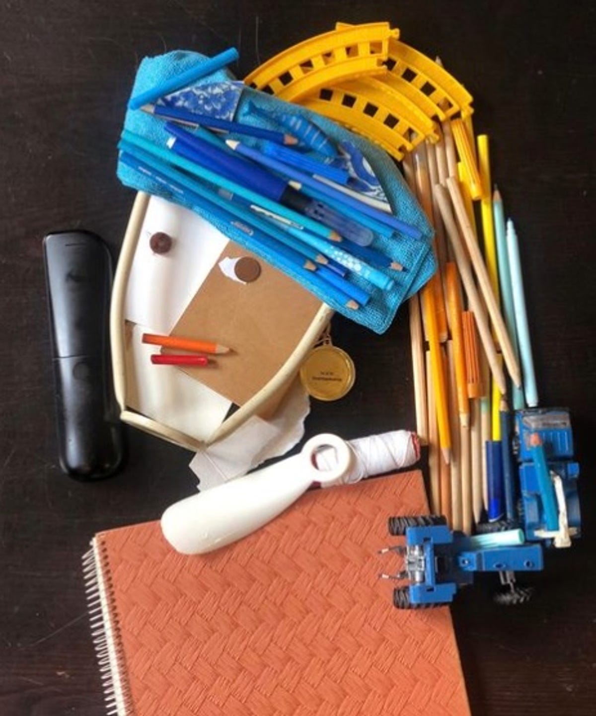 Pencils and other school supplies in the shape of girl with pearl earring